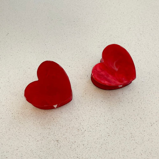 zwei kleine rote Herzhaarklammern